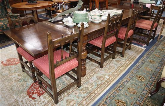 A reproduction oak draw leaf dining table and eight chairs, (two with arms) Table 320cm extended